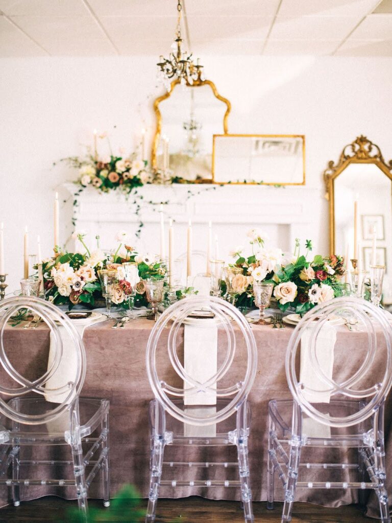 Garden-inspired bridal shower tablescape with pastel florals, vintage candle holders, and gold-accented details inside Vella Nest Floral’s Dallas studio.