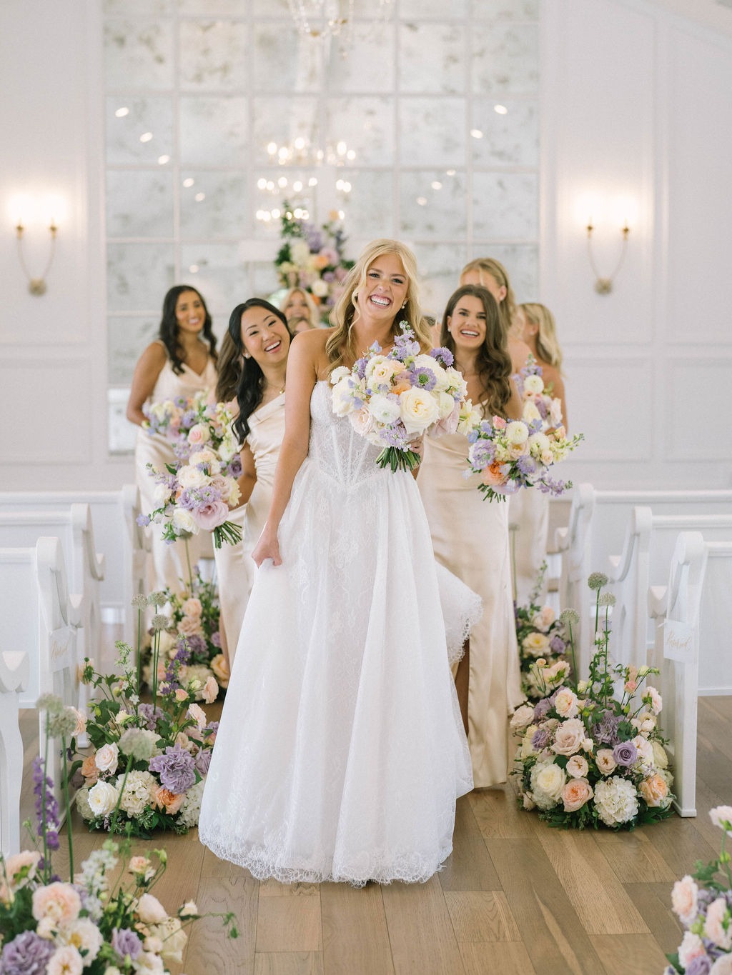 Bride walking down chapel aisle with pastel bouquet at The Nest at Ruth’s Farm